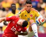 Pemain Swiss Granit Xhaka (merah) dan kapten Kolombia James Rodriguez (kuning) berebut bola di BC Place, Rabu (8/7/2026). (AFP)